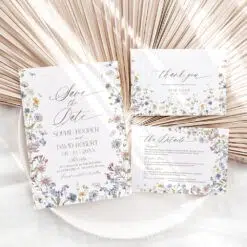 Minimalist wedding invitation and save the date card with hand-drawn wildflower illustrations and modern fonts on white background.
