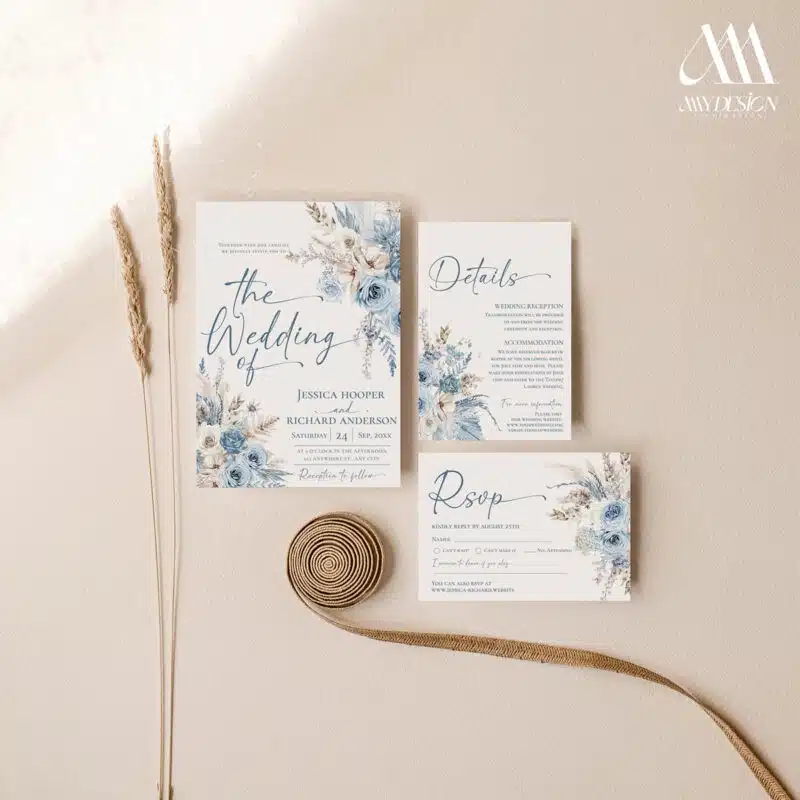 Dusty blue boho wedding invitation with pampas grass and floral design